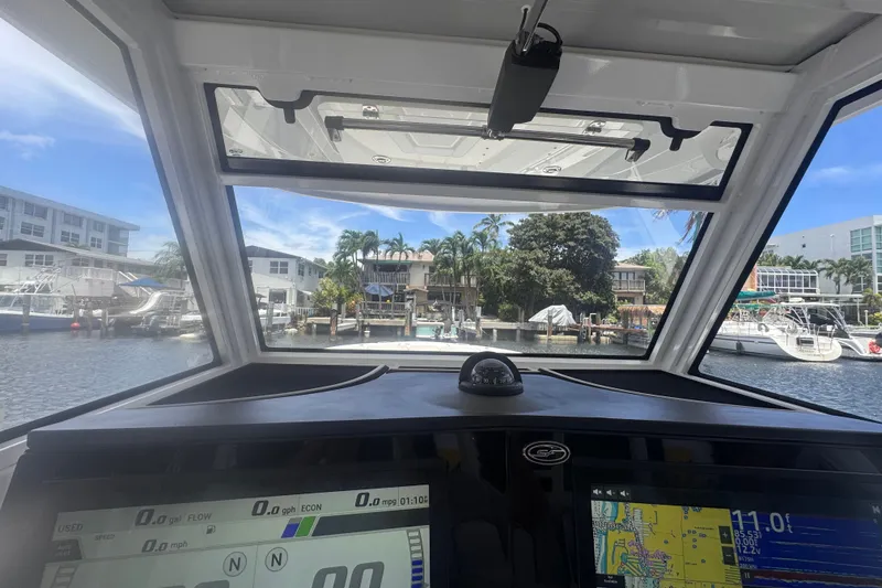 Slide: The Image of Interior view from 2023 Sea Fox 368 Commander boat, overlooking marina and waterfront homes. - 7