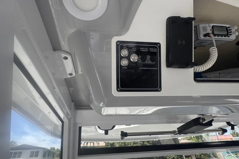 Slide: The Image of Control panel of 2023 Sea Fox 368 Commander boat with switches and radio. - 18