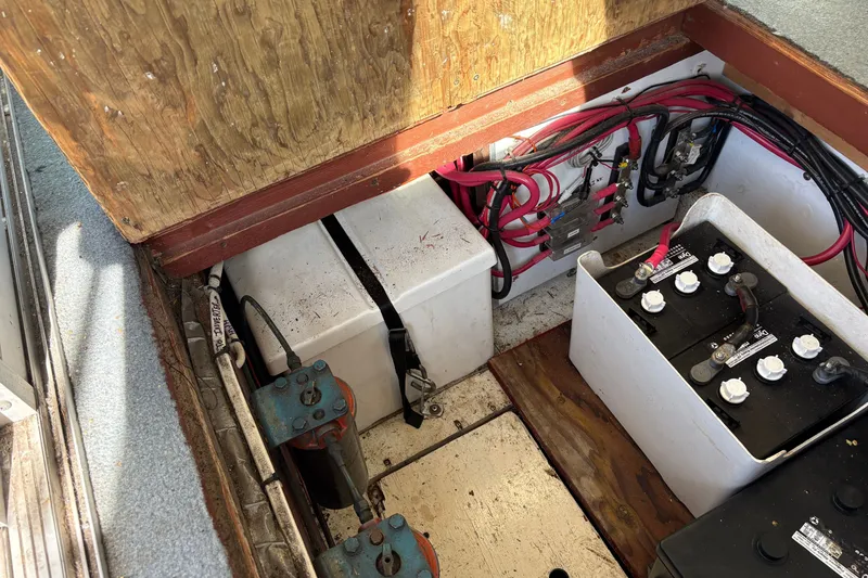 Slide: The Image of 1978 Mainship 34 Trawler engine compartment with batteries and wiring. - 34