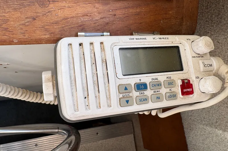 Slide: The Image of VHF marine radio on 1978 Mainship 34 Trawler, featuring distress button and control knobs. - 21