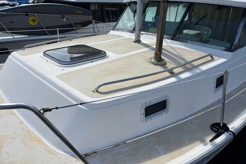 Slide: The Image of 1978 Mainship 34 Trawler boat deck with hatch and railing in marina. - 3