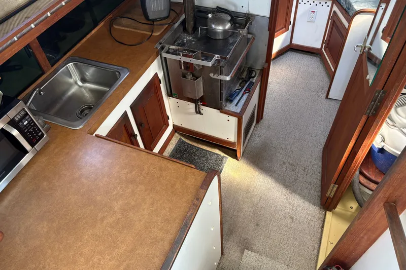 Slide: The Image of 1978 Mainship 34 Trawler galley with sink, stove, and microwave. - 24