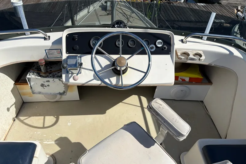 Slide: The Image of 1978 Mainship 34 Trawler helm with steering wheel and control panel. - 13