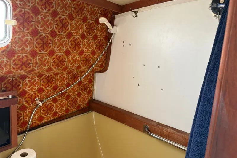 Slide: The Image of Interior of 1978 Mainship 34 Trawler with vintage patterned wall and shower fixture. - 31