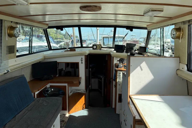 Slide: The Image of Interior of a 1978 Mainship 34 Trawler with nautical decor and marina view. - 14