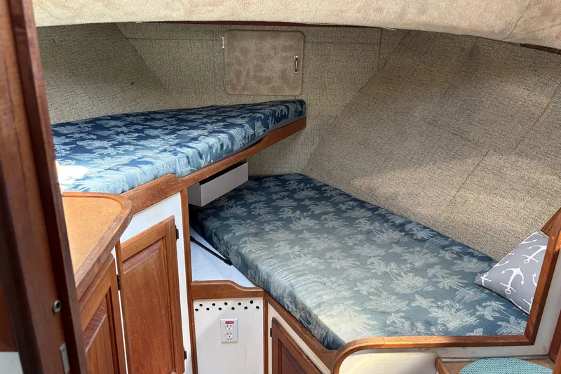 Slide: The Image of 1978 Mainship 34 Trawler cabin with twin beds and nautical-themed decor. - 28