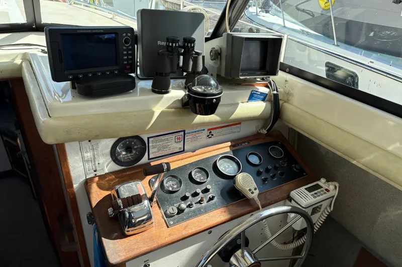 Slide: The Image of 1978 Mainship 34 Trawler helm with navigation equipment and steering wheel. - 15