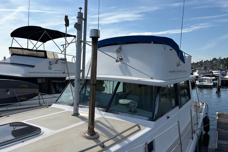 Slide: The Image of 1978 Mainship 34 Trawler docked at marina under clear blue sky. - 2
