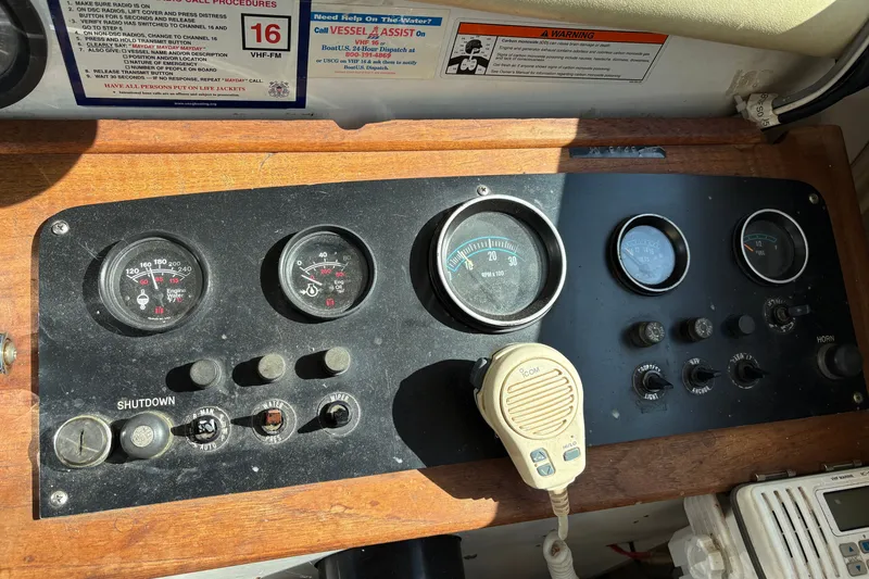 Slide: The Image of 1978 Mainship 34 Trawler dashboard with gauges, controls, and a microphone. - 16
