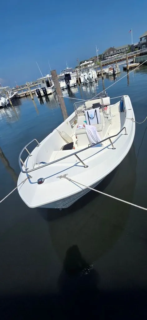 Slide: The Image of A white boat docked, with towels draped over the seats. - 3
