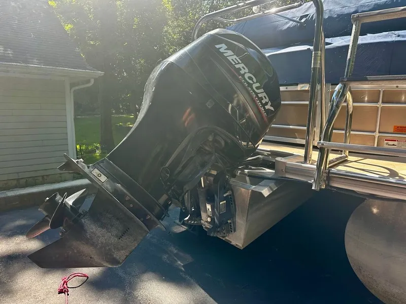 Slide: The Image of A Mercury outboard motor is attached to a pontoon boat, which is on a trailer. - 20