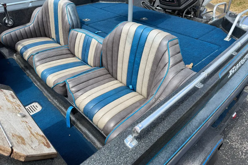 Slide: The Image of 1989 Ranger 373V boat interior with blue and gray striped seats. - 3