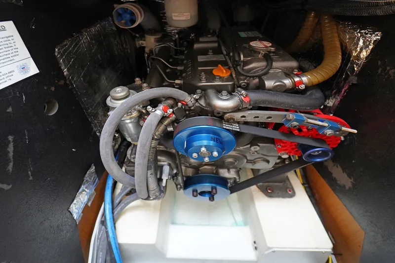 Slide: The Image of Engine compartment of a 2011 Jeanneau Sun Odyssey 50 DS sailboat, showcasing mechanical components. - 35
