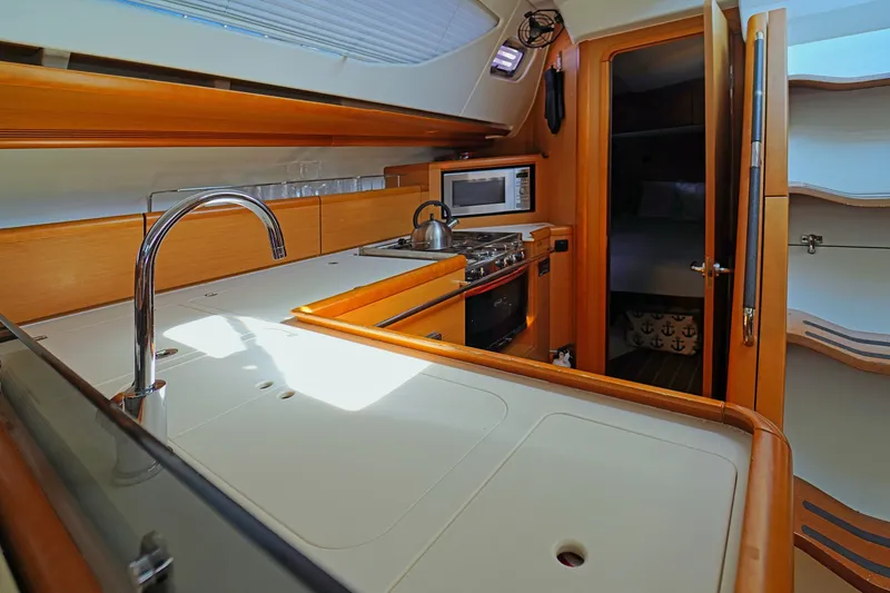 Slide: The Image of Interior of 2011 Jeanneau Sun Odyssey 50 DS yacht kitchen with modern amenities. - 25