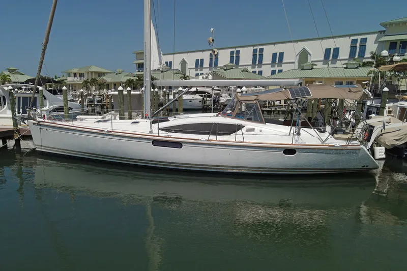 Slide: The Image of 2011 Jeanneau Sun Odyssey 50 DS sailboat docked at marina, clear sky background. - 4