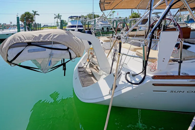 Slide: The Image of Jeanneau Sun Odyssey 50 DS yacht, 2011 model, docked with covered dinghy at stern. - 13