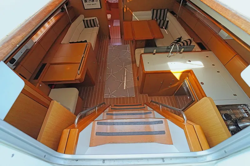 Slide: The Image of Interior of 2011 Jeanneau Sun Odyssey 50 DS yacht, featuring elegant wood finishes and spacious layout. - 18