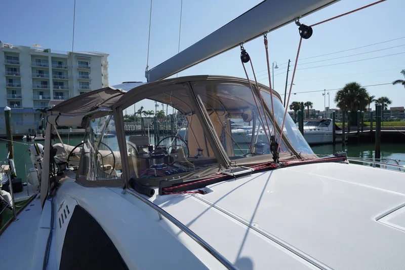 Slide: The Image of 2011 Jeanneau Sun Odyssey 50 DS sailboat docked at marina, featuring cockpit and canopy. - 12