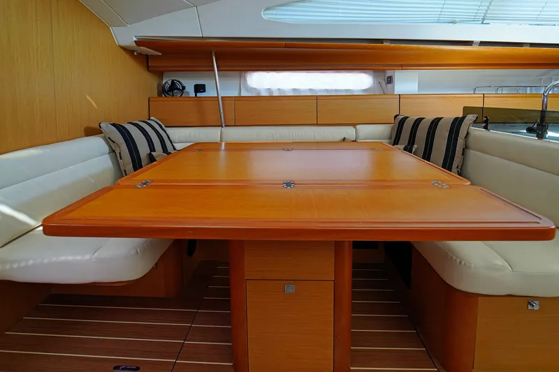 Slide: The Image of Interior of 2011 Jeanneau Sun Odyssey 50 DS yacht with wooden dining table and cushioned seating. - 23