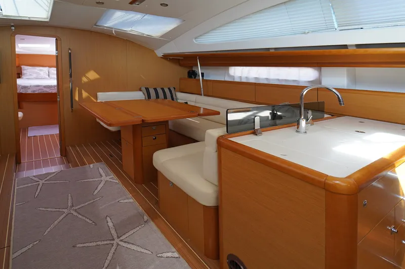 Slide: The Image of Interior of 2011 Jeanneau Sun Odyssey 50 DS yacht with modern kitchen and dining area. - 21