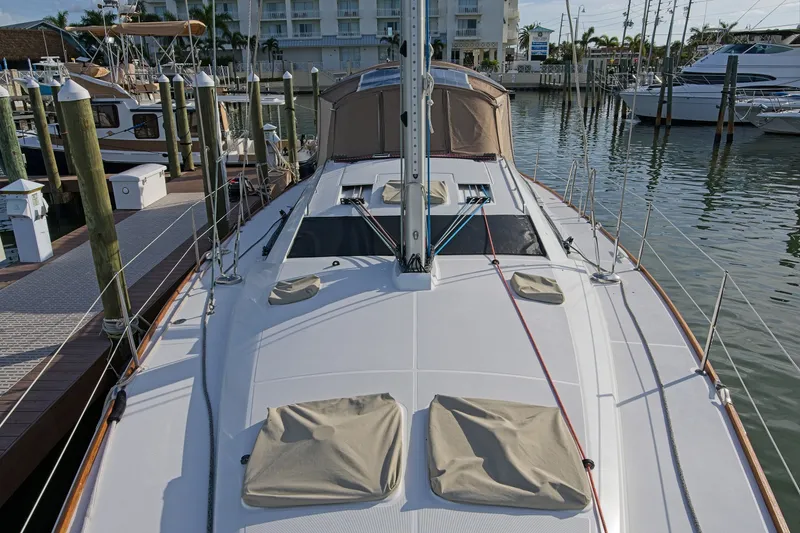 Slide: The Image of 2011 Jeanneau Sun Odyssey 50 DS sailboat docked at marina, showcasing deck and rigging. - 9