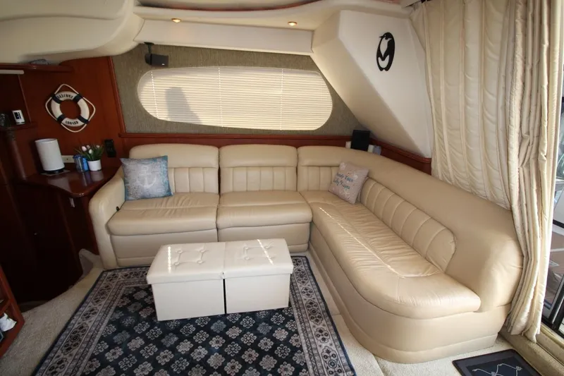 Slide: The Image of Luxurious interior of 2004 Silverton 410 Sport Bridge with beige leather seating and nautical decor. - 24