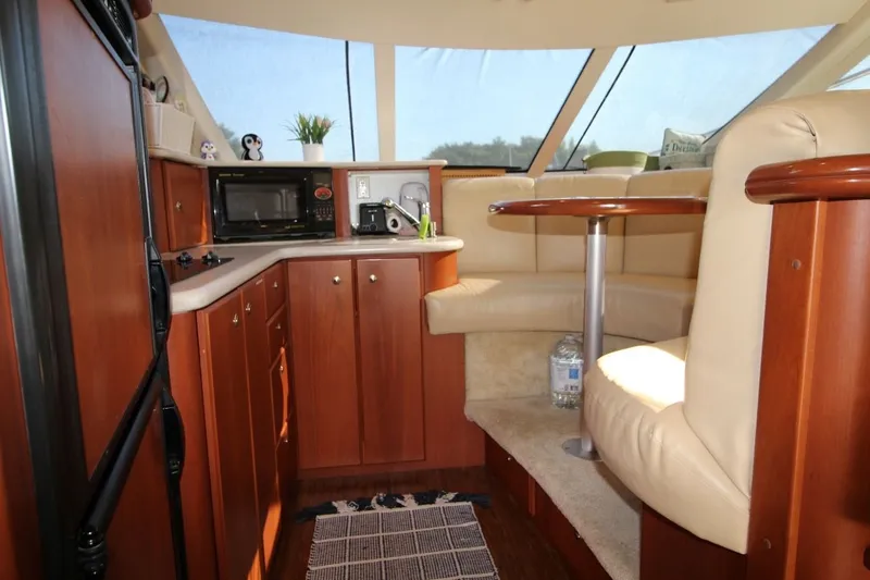 Slide: The Image of Interior of 2004 Silverton 410 Sport Bridge with kitchen and seating area. - 25