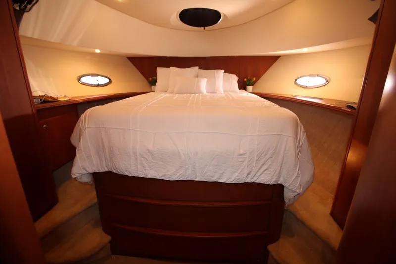 Slide: The Image of Luxurious bedroom interior of 2004 Silverton 410 Sport Bridge yacht with elegant wood finish. - 30