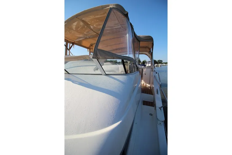 Slide: The Image of 2004 Silverton 410 Sport Bridge yacht with sleek design and canopy, docked by the water. - 15