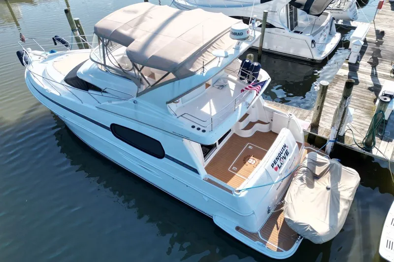 The Image of 2004 Silverton 410 Sport Bridge yacht docked at marina, aerial view. - 2