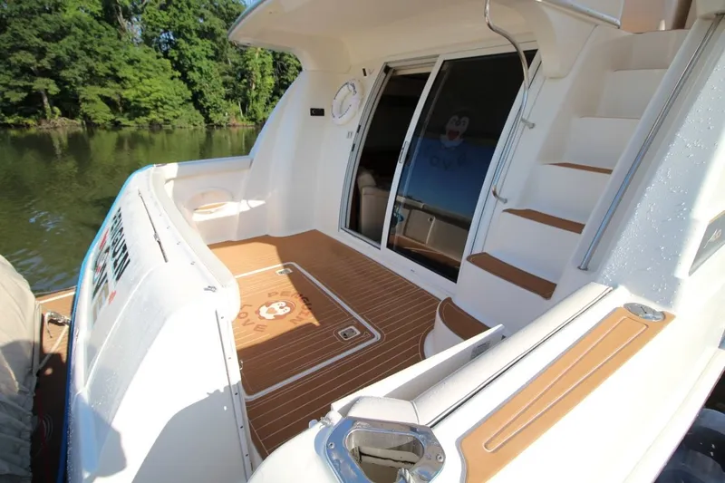 Slide: The Image of 2004 Silverton 410 Sport Bridge yacht deck with stairs and sliding glass doors. - 21