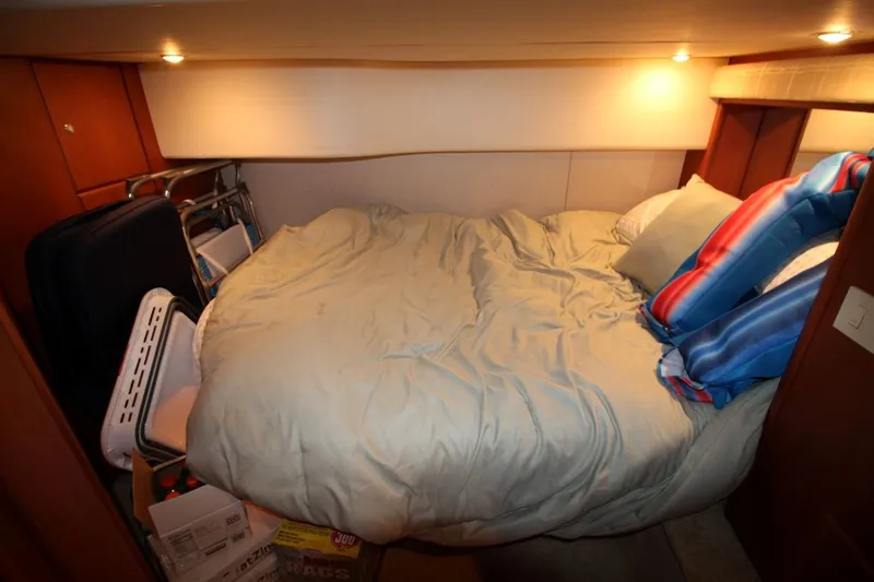 Slide: The Image of Cozy bedroom in 2004 Silverton 410 Sport Bridge yacht with storage items. - 29