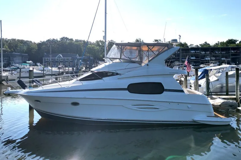 Slide: The Image of 2004 Silverton 410 Sport Bridge yacht docked in a marina, surrounded by other boats. - 8
