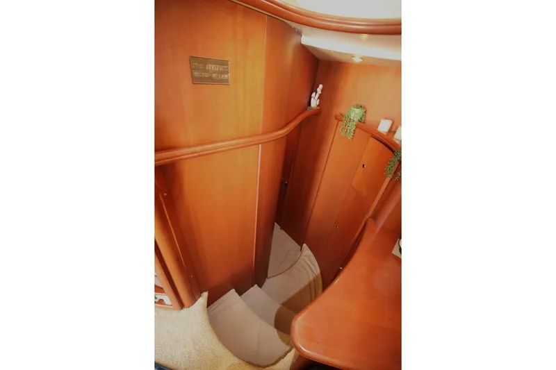 Slide: The Image of Interior view of 2004 Silverton 410 Sport Bridge with wooden paneling and carpeted stairs. - 28