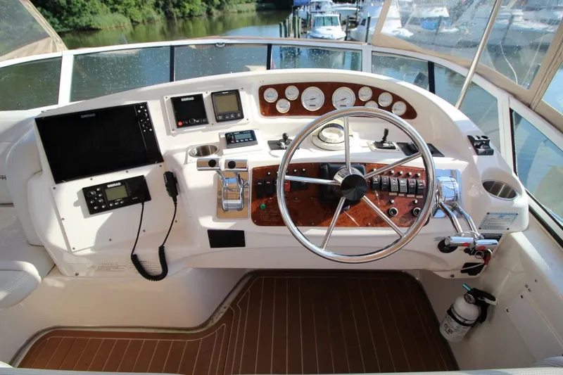 Slide: The Image of Cockpit of 2004 Silverton 410 Sport Bridge with steering wheel and navigation controls. - 14