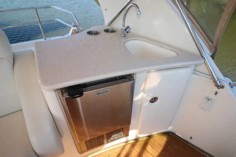 Slide: The Image of 2004 Silverton 410 Sport Bridge yacht kitchenette with sink and mini fridge. - 17
