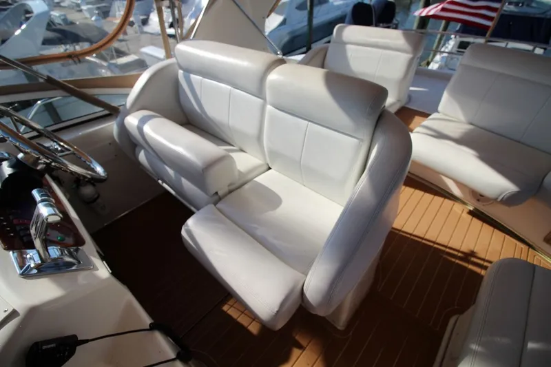 Slide: The Image of 2004 Silverton 410 Sport Bridge interior with white leather seating and wooden flooring. - 12