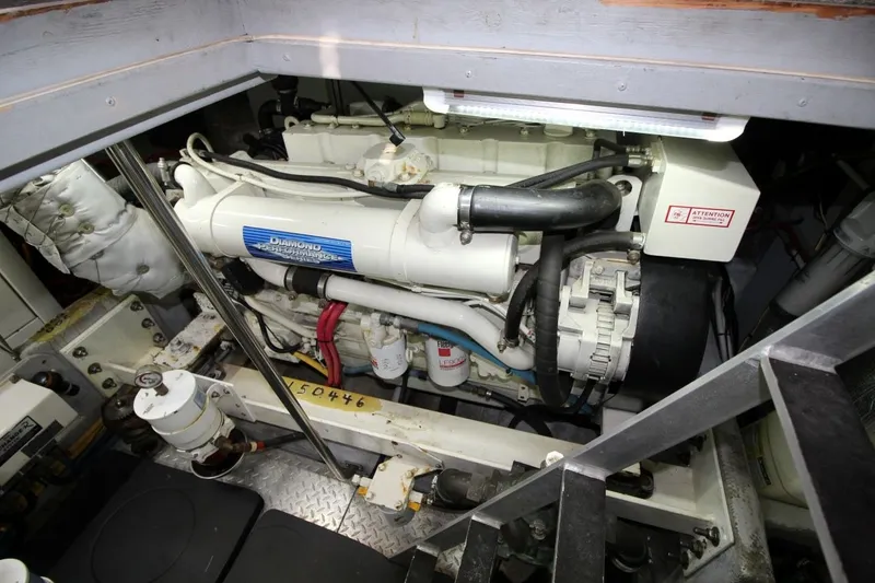Slide: The Image of Engine room of a 2004 Silverton 410 Sport Bridge yacht, showcasing mechanical components. - 36