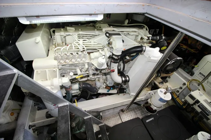 Slide: The Image of Engine room of a 2004 Silverton 410 Sport Bridge yacht, showcasing detailed machinery. - 34