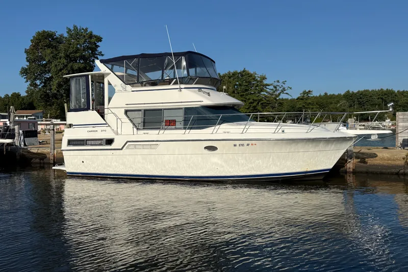 The Image of 1995 Carver 370 Aft Cabin Motor Yacht docked, with "For Sale" sign visible. - 0