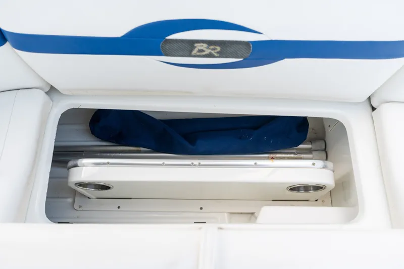 Slide: The Image of Storage compartment in a 2008 Formula 310 Bowrider boat, featuring a folded table. - 37