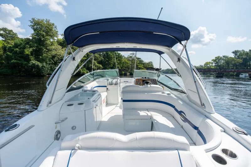 Slide: The Image of 2008 Formula 310 Bowrider boat with spacious seating, cruising on a scenic river. - 39