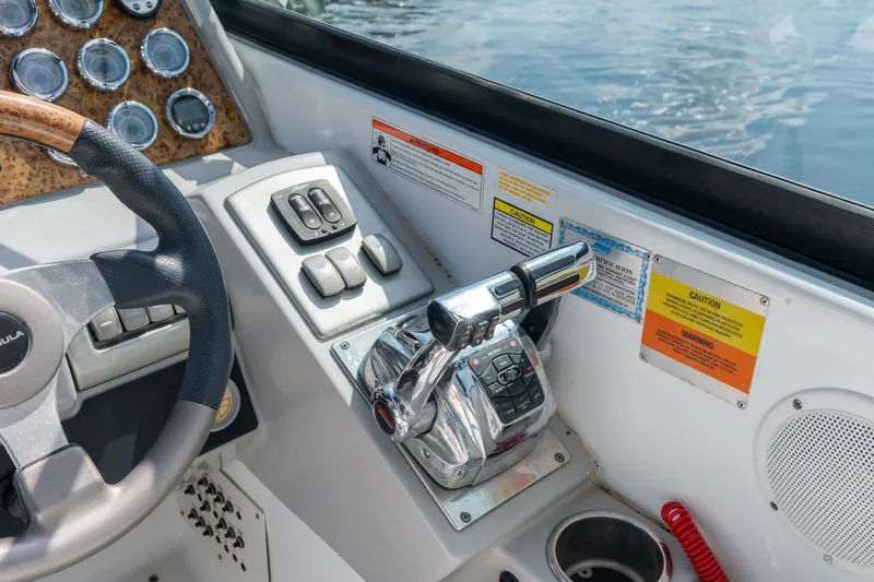 Slide: The Image of Control panel of a 2008 Formula 310 Bowrider boat with steering wheel and throttle. - 30