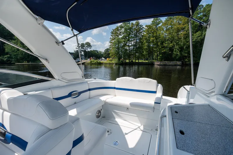 Slide: The Image of 2008 Formula 310 Bowrider interior with white seating, blue accents, and scenic lake view. - 32