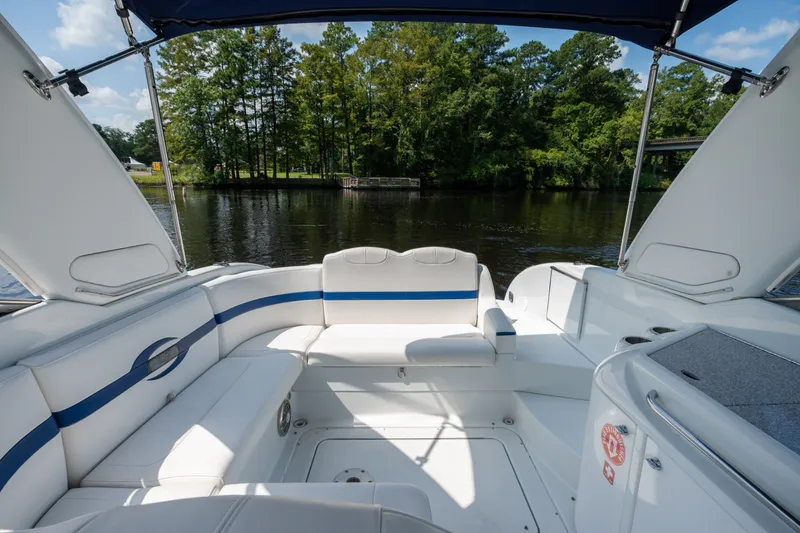 Slide: The Image of 2008 Formula 310 Bowrider boat interior with white seating, blue accents, and scenic water view. - 33