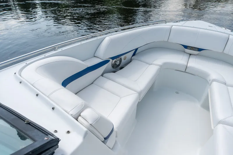 Slide: The Image of 2008 Formula 310 Bowrider boat with spacious white seating area on calm water. - 12