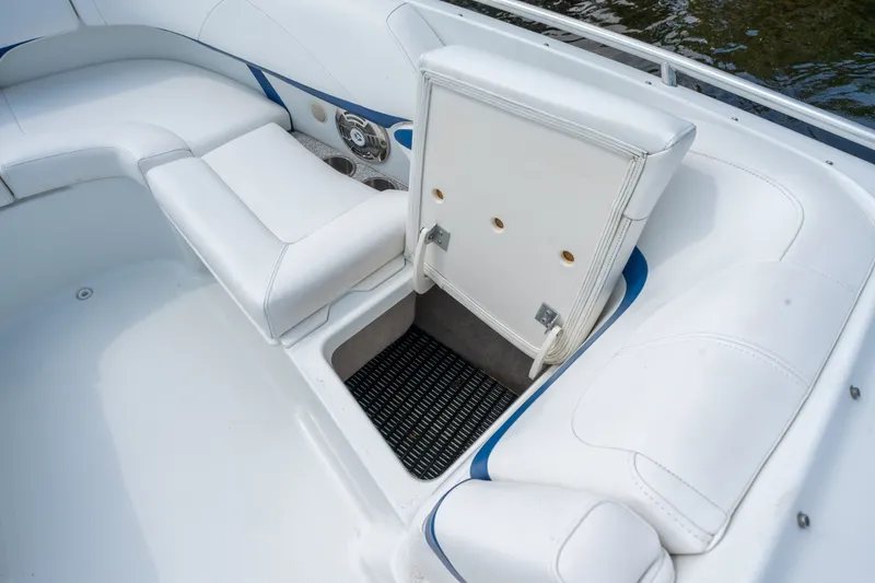 Slide: The Image of 2008 Formula 310 Bowrider interior with open storage compartment and white seating. - 16