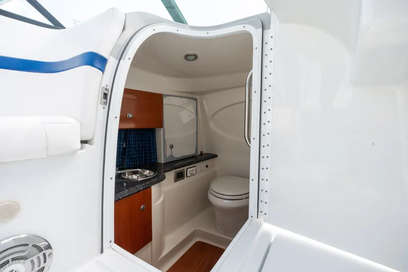 Slide: The Image of Interior of 2008 Formula 310 Bowrider boat featuring compact bathroom amenities. - 21