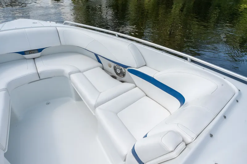 Slide: The Image of 2008 Formula 310 Bowrider with white and blue seating, docked on calm water. - 13