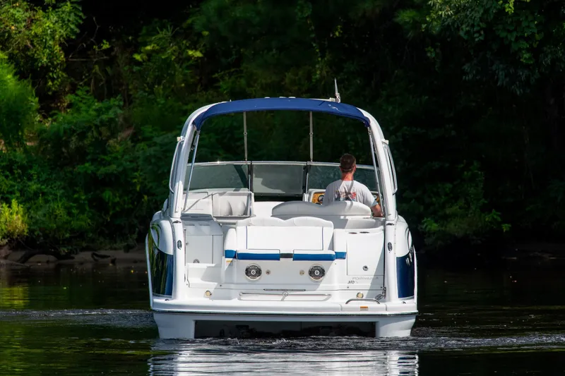 Slide: The Image of 2008 Formula 310 Bowrider cruising on a calm river, surrounded by lush greenery. - 5